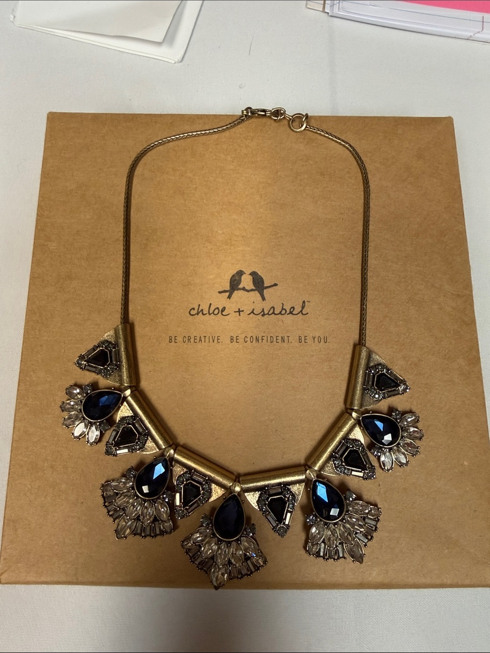 chloe + isabel Monarch statement necklace with gold tones andNavy Blue Gemstones